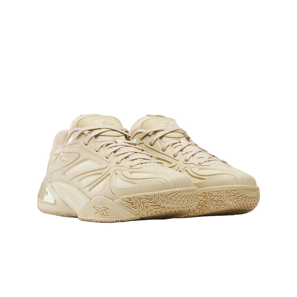 Tan Reebok sneakers with textured sole and modern layered detailing, premium footwear