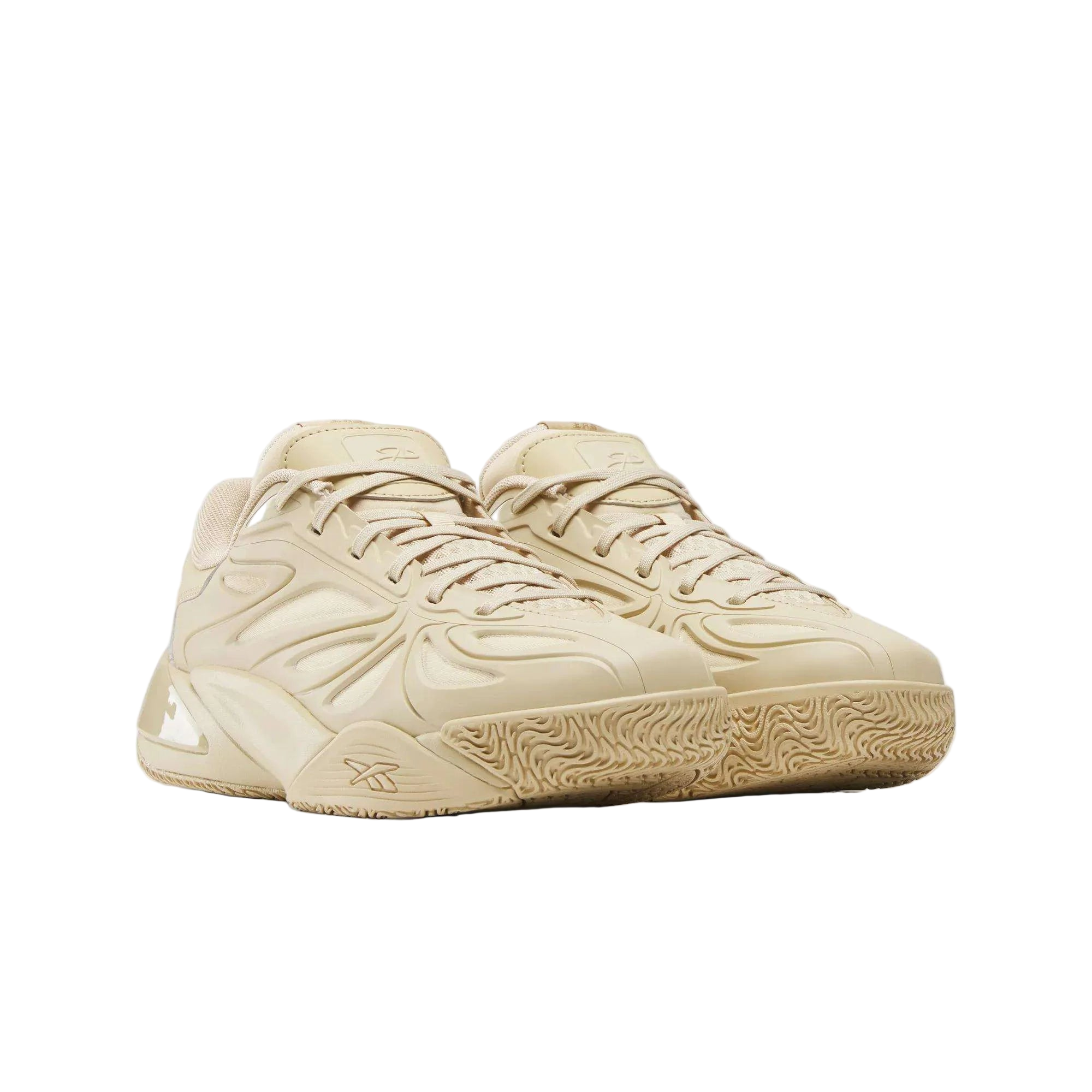 Tan Reebok sneakers with textured sole and modern layered detailing, premium footwear