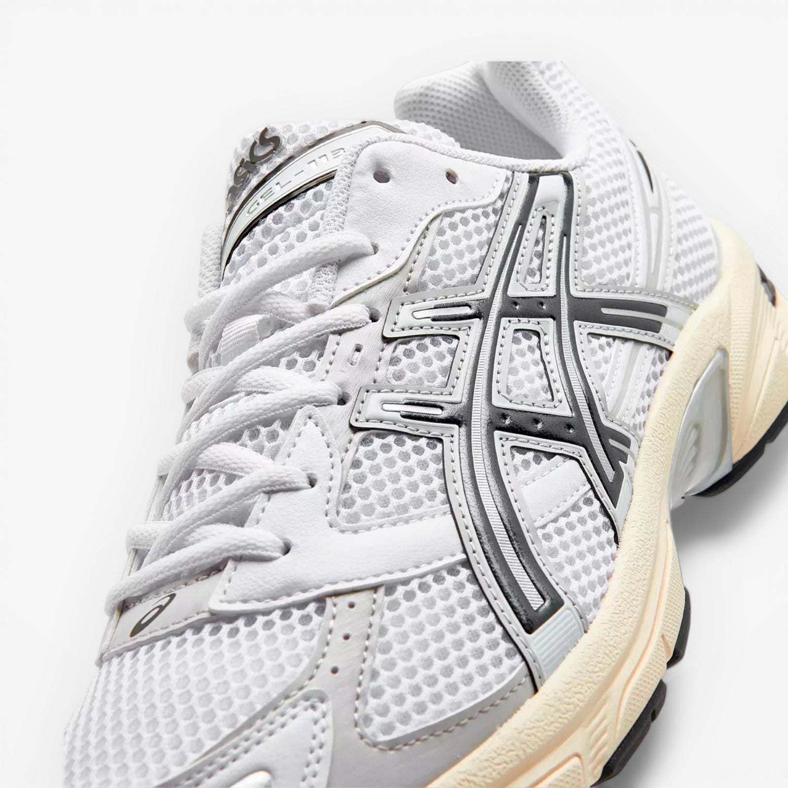 ASICS white mesh sneaker with silver and black accents, modern footwear design