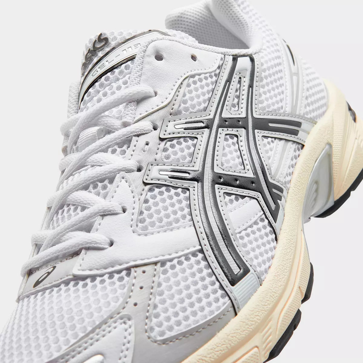 ASICS white mesh sneaker with silver and black accents, modern footwear design