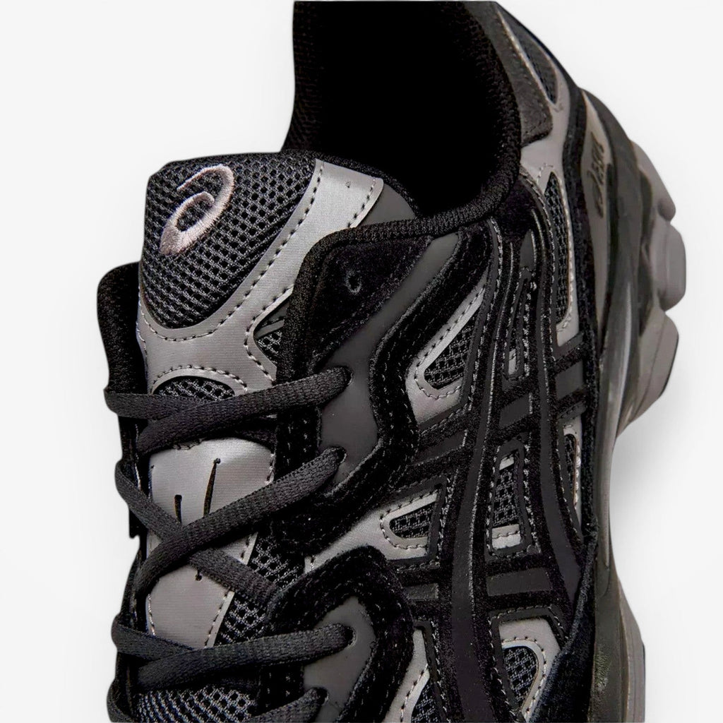 ASICS sneaker closeup showing black mesh and synthetic upper, part of athletic footwear collection