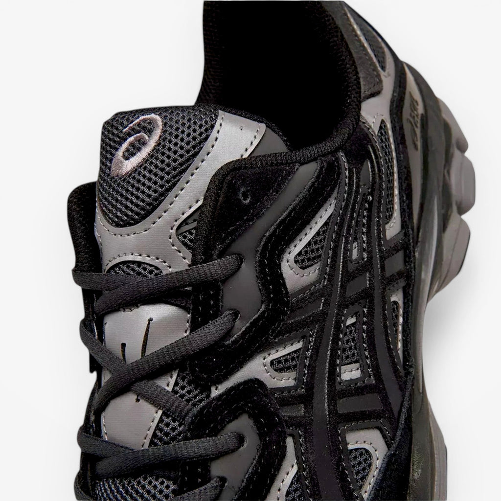 ASICS sneaker closeup showing black mesh and synthetic upper, part of athletic footwear collection