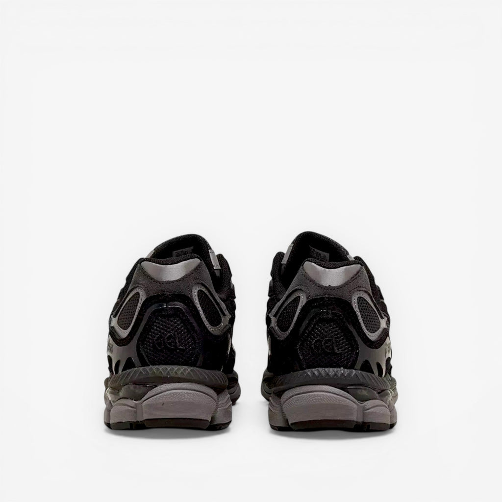 Back view of black ASICS sneakers with mesh and suede detailing, footwear for men