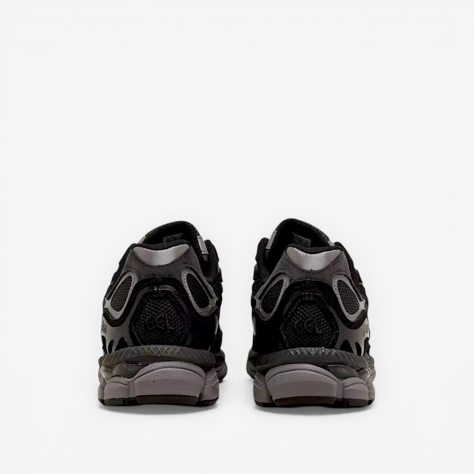 Back view of black ASICS sneakers with mesh and suede detailing, footwear for men