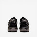 Back view of black ASICS sneakers with mesh and suede detailing, footwear for men