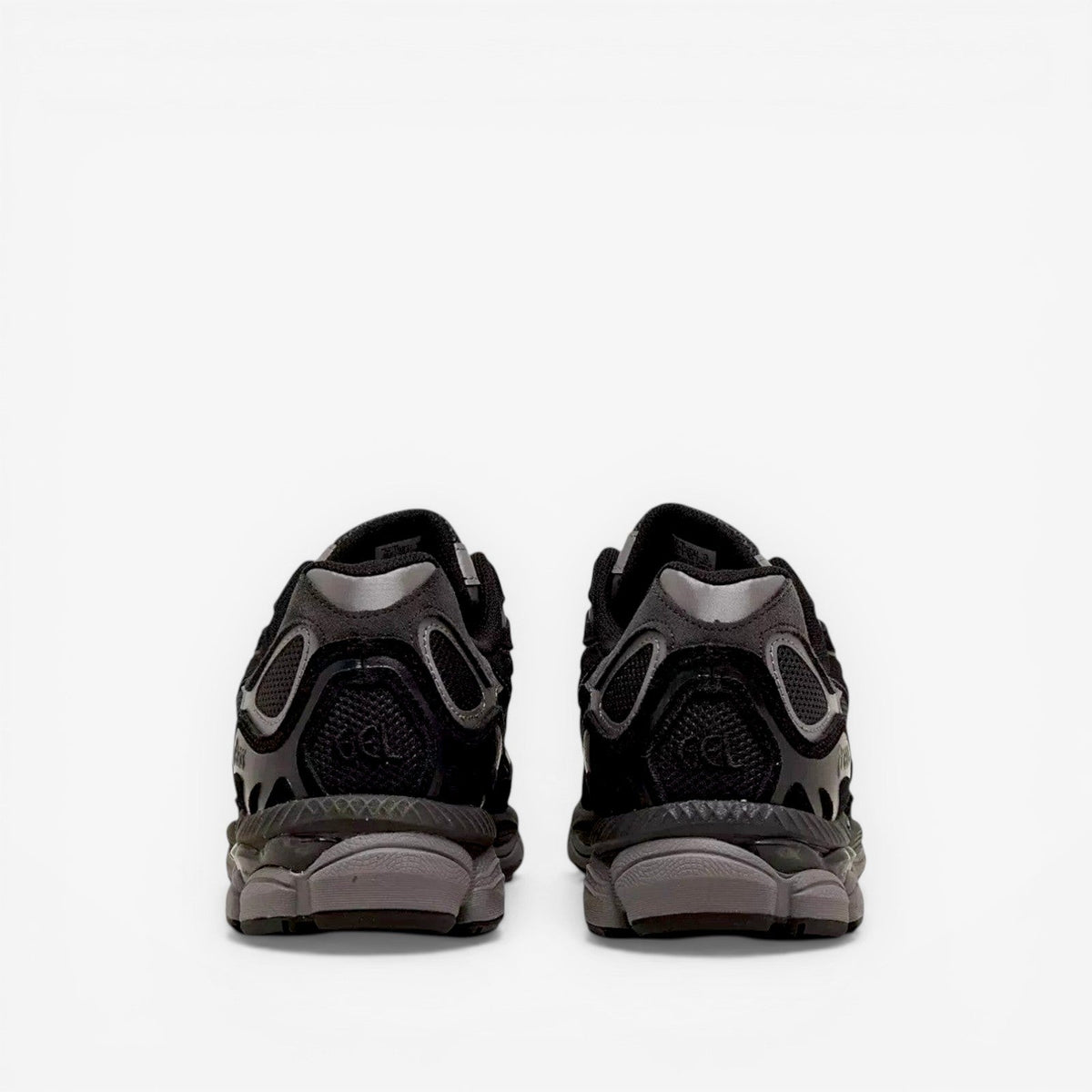 Back view of black ASICS sneakers with mesh and suede detailing, footwear for men