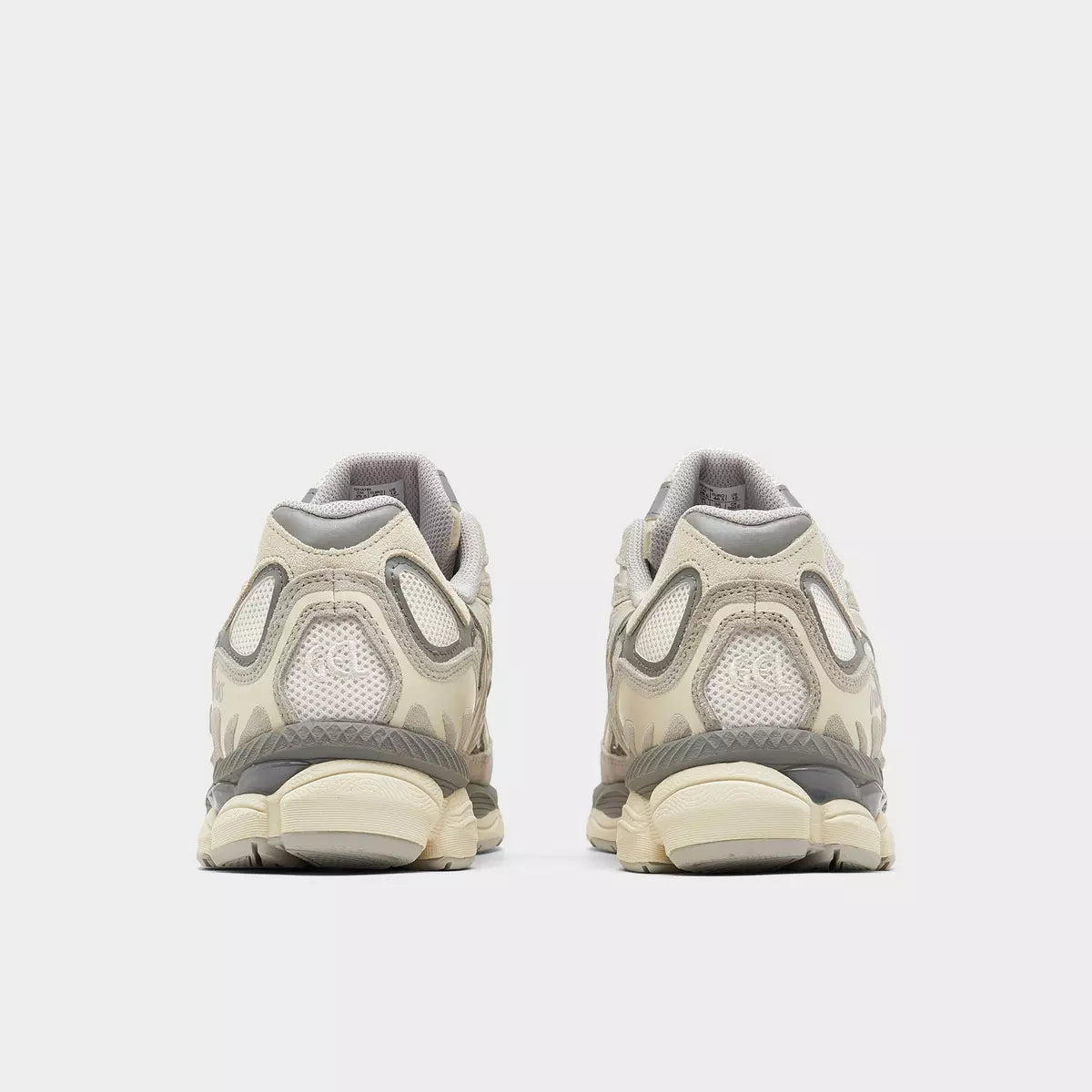 Rear view of beige ASICS sneakers with mesh and suede details, neutral background, footwear