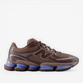 New Balance brown sneakers with mesh upper and unique blue cushioned soles, footwear fashion