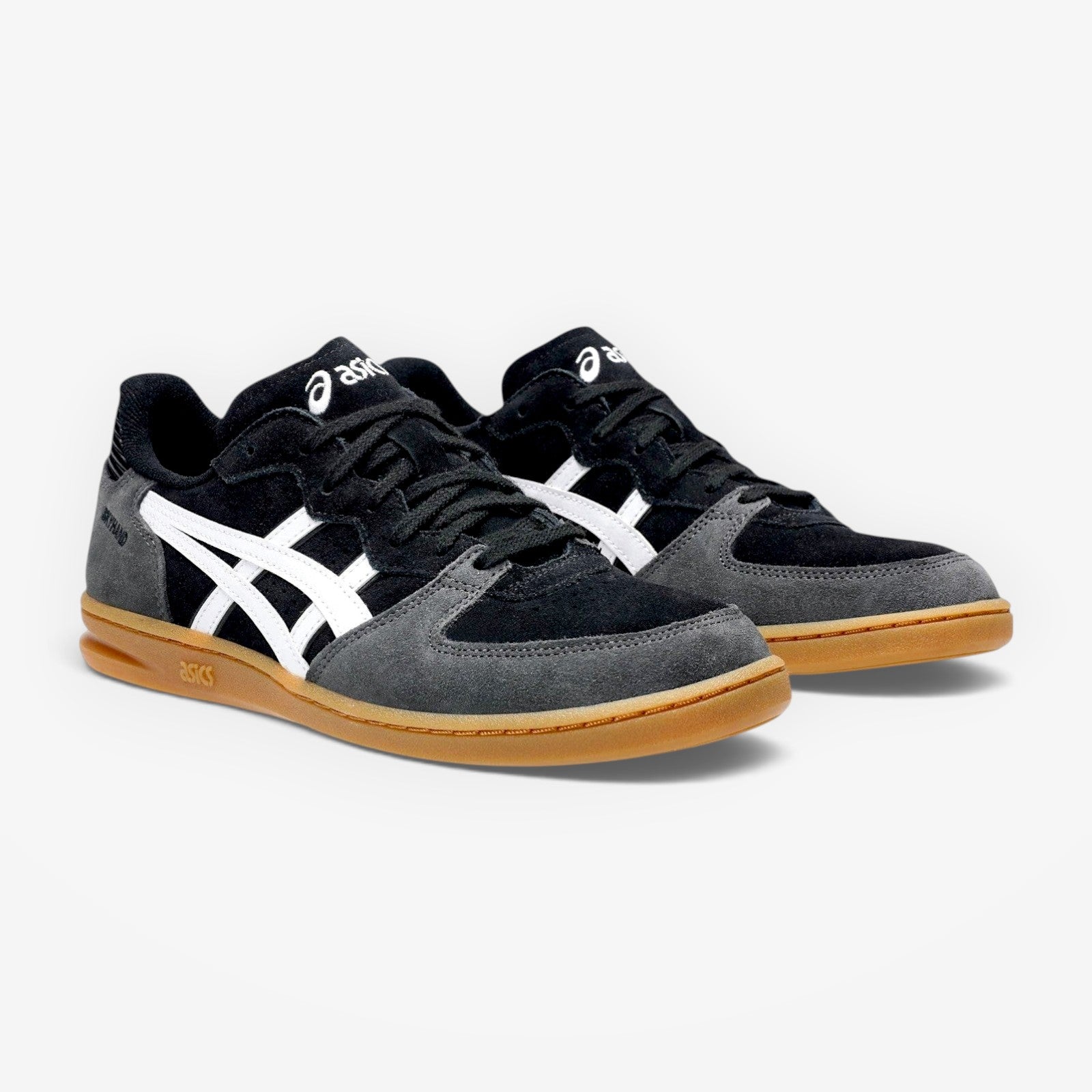 Black and gray sneakers with white logo on a white background
