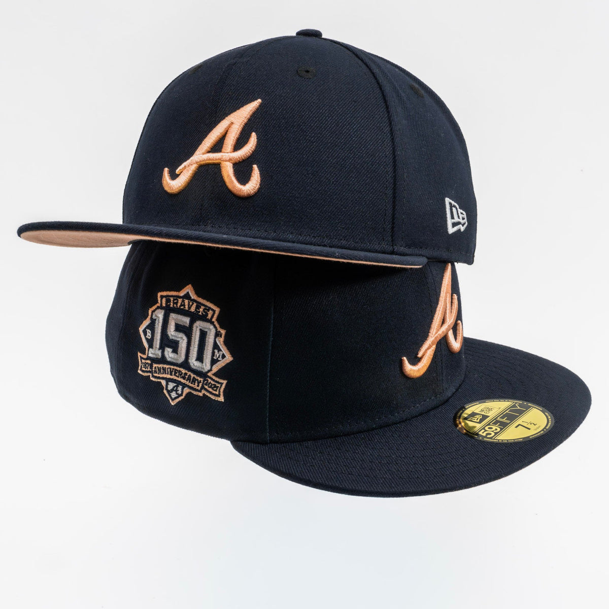 A black Atlanta Braves 150th anniversary fitted baseball cap by New Era, featuring a tan leather-look 'A' logo on the front and side, a gold 150th anniversary patch on the brim, and a gold New Era logo on the side.