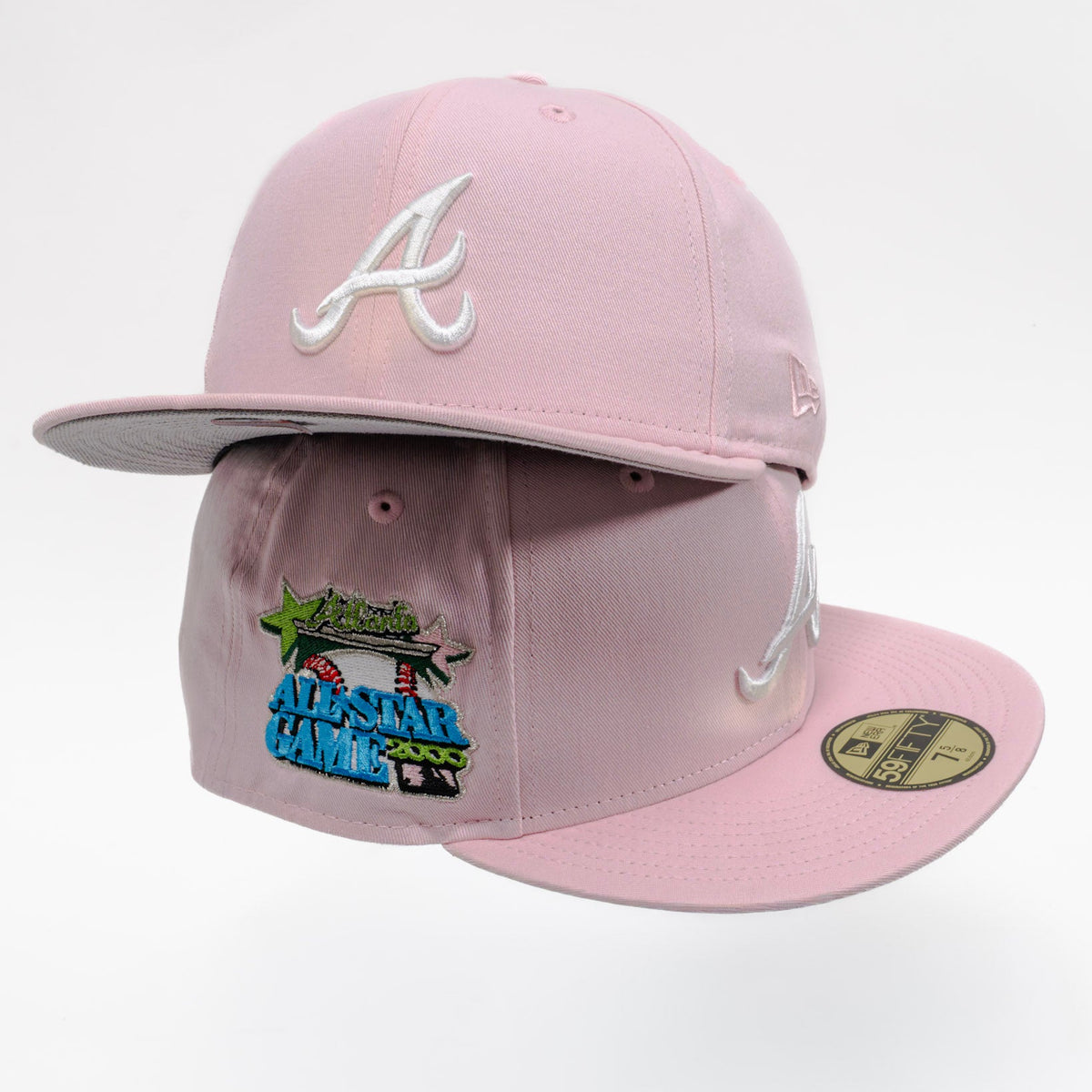 A light pink Atlanta Braves fitted baseball cap featuring a white embroidered 'A' logo on the front, a 'All-Star Game' patch on the side, and a gold size sticker on the brim, set against a plain white background.