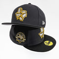 A black Houston Rockets 45th Anniversary fitted baseball cap by New Era, featuring a gold and white embroidered Texas star logo on the front, a gold and black anniversary patch on the front panel, and a gold size sticker on the brim.