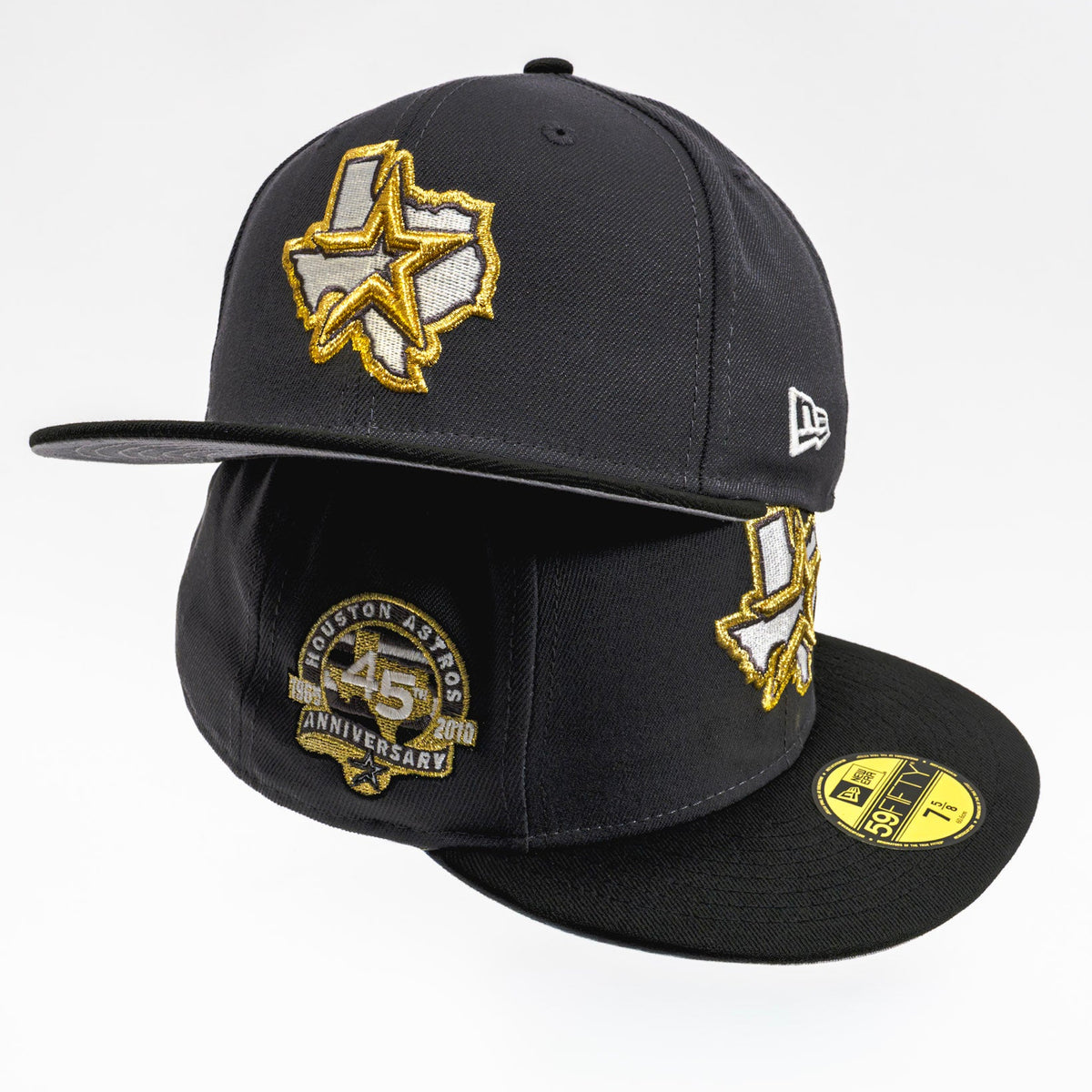 A black Houston Rockets 45th Anniversary fitted baseball cap by New Era, featuring a gold and white embroidered Texas star logo on the front, a gold and black anniversary patch on the front panel, and a gold size sticker on the brim.