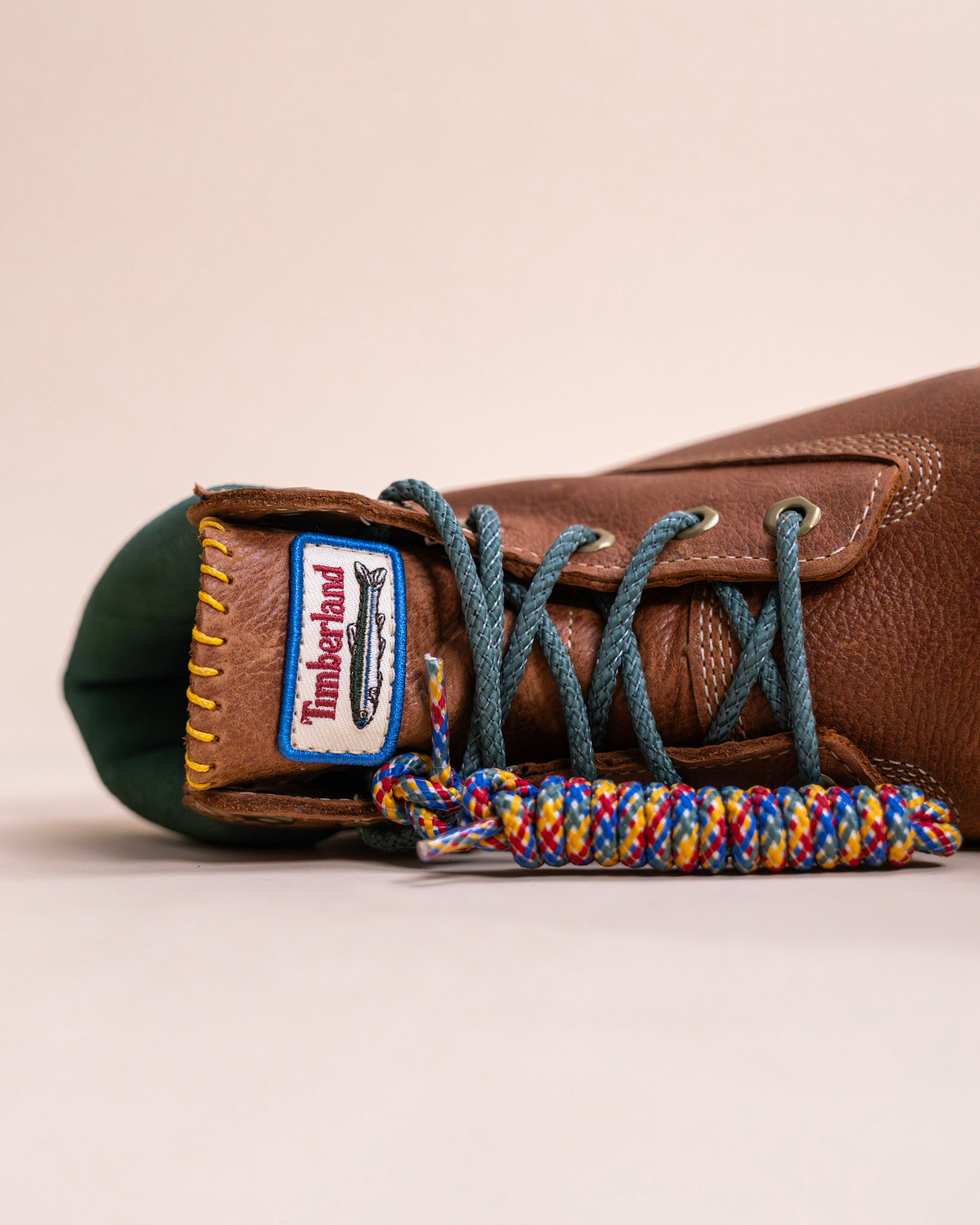 Brown leather sneaker with blue laces, close-up, footwear, new balance, asics, hats, fitted caps, new era.