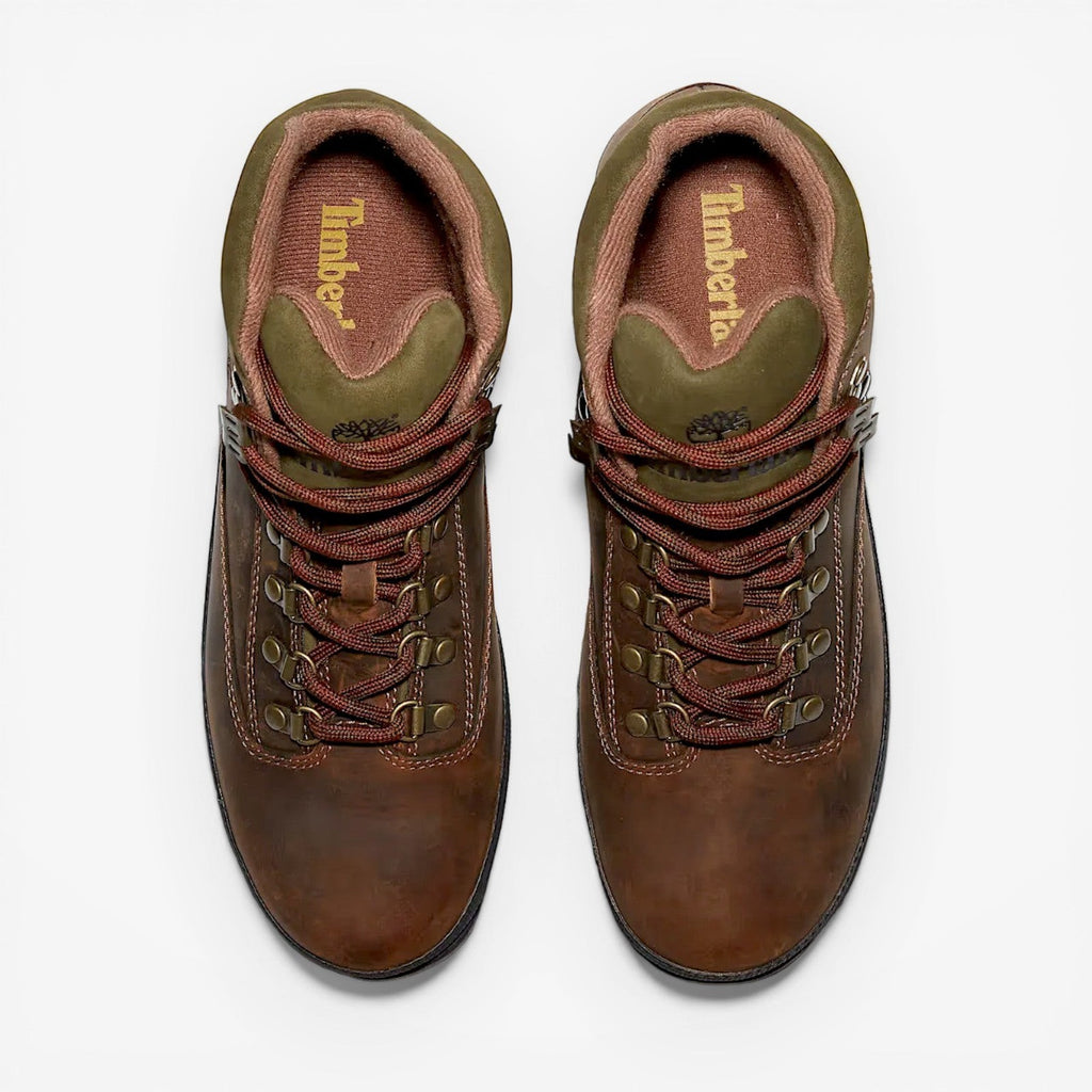 Pair of brown leather boots with red laces on a white background, featuring the Timberland logo.
