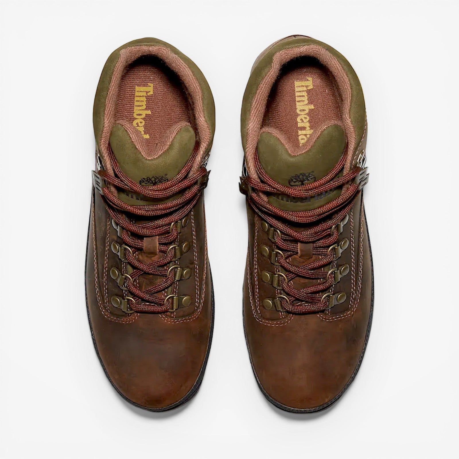 Pair of brown leather boots with red laces on a white background, featuring the Timberland logo.