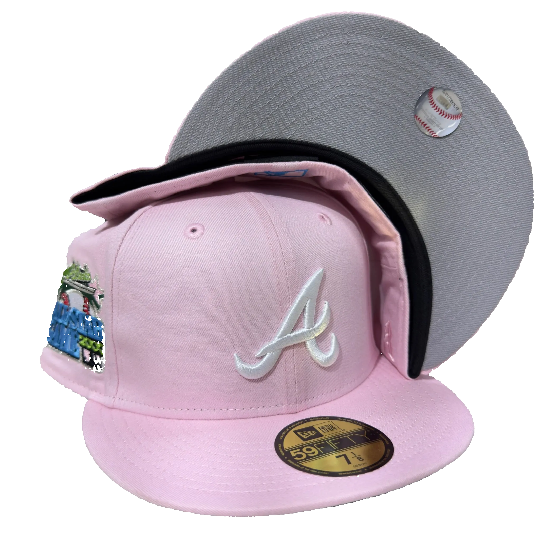 Pink New Era fitted cap with white A logo, side patch, grey underbrim, and baseball sticker