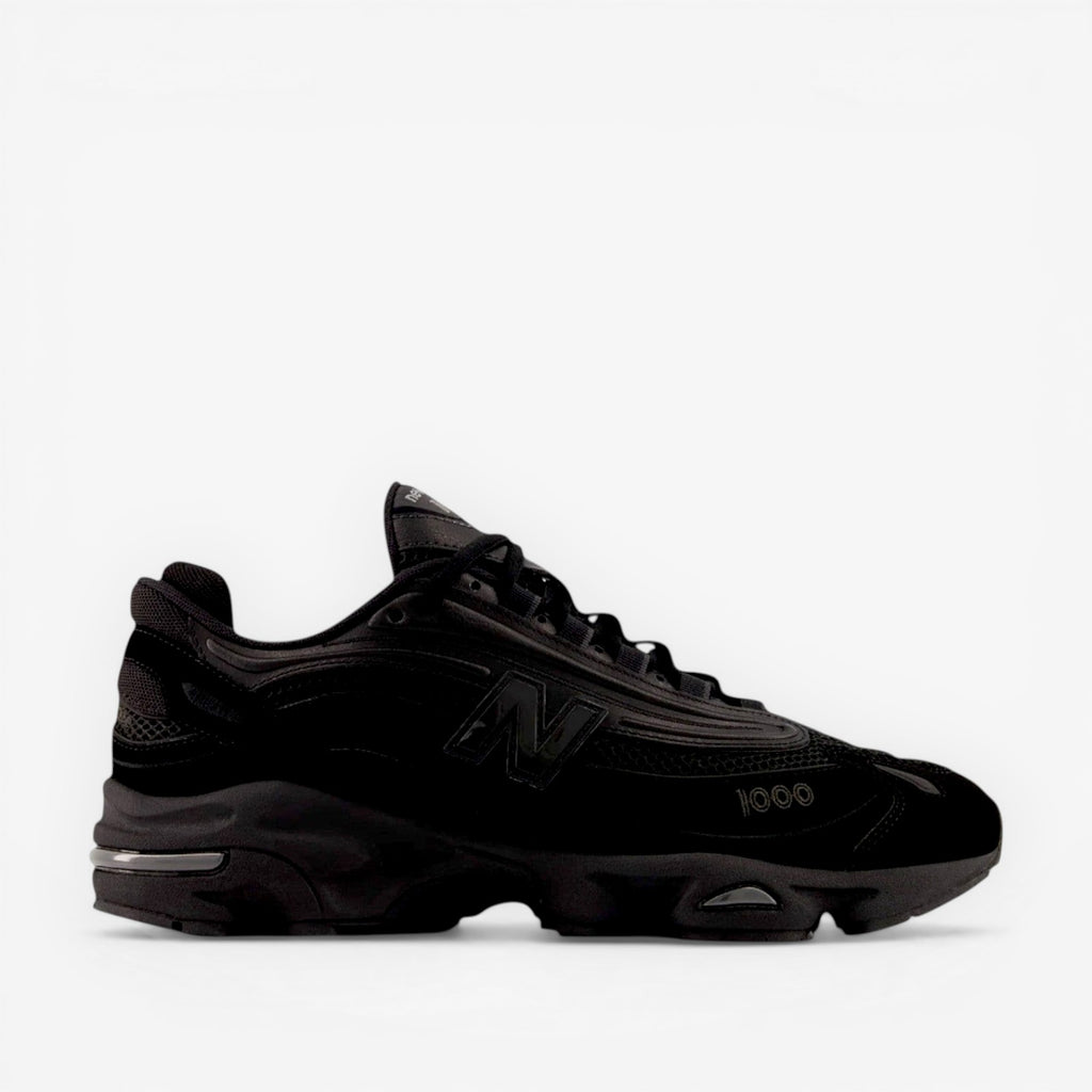 Black New Balance sneaker, mesh and suede, side profile, athletic footwear