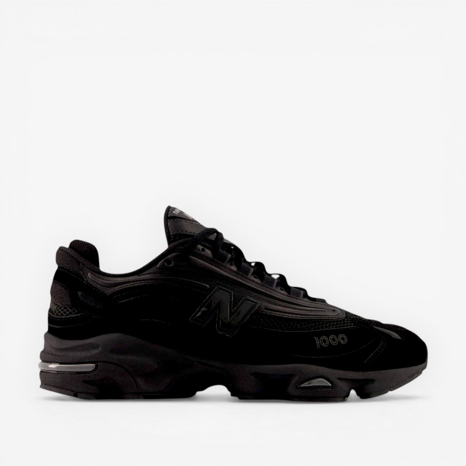 Black New Balance sneaker, mesh and suede, side profile, athletic footwear