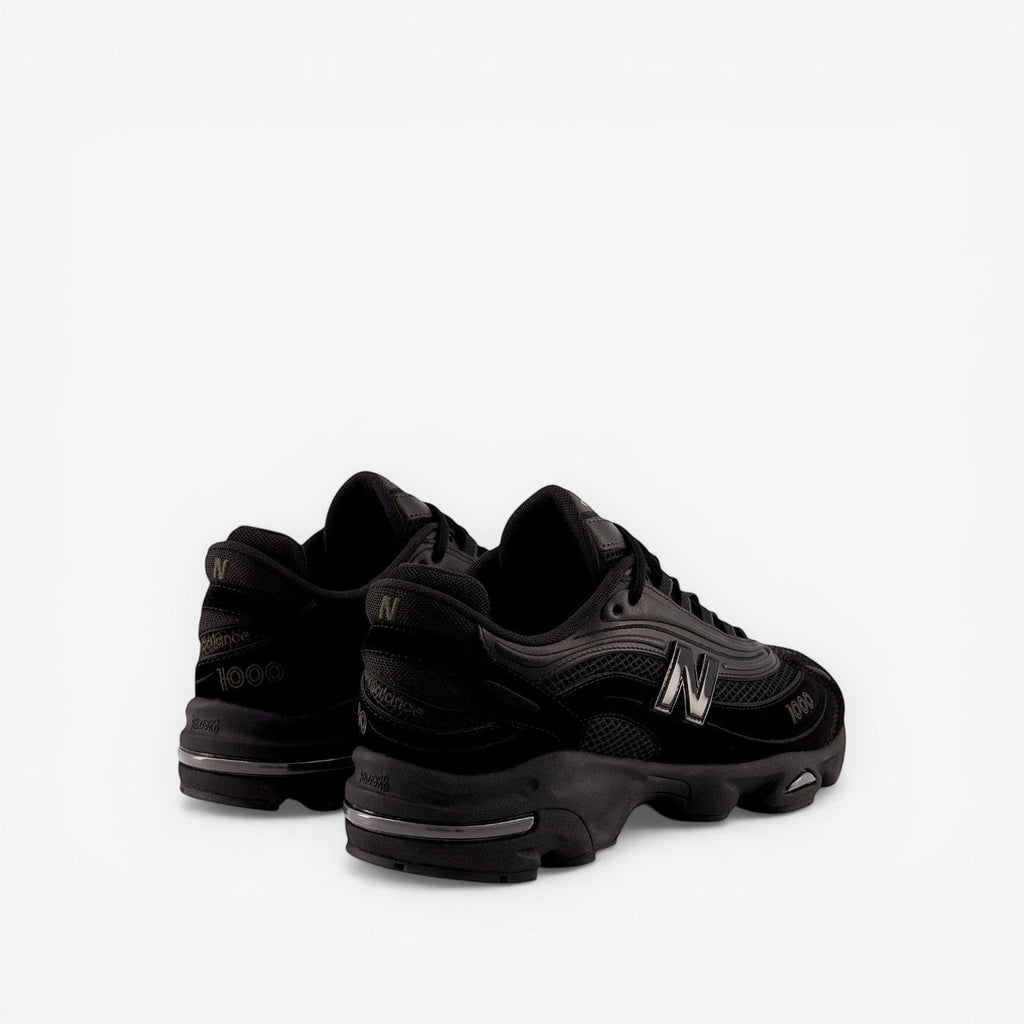 New Balance black sneakers, mesh and suede upper, bold N logo, premium footwear