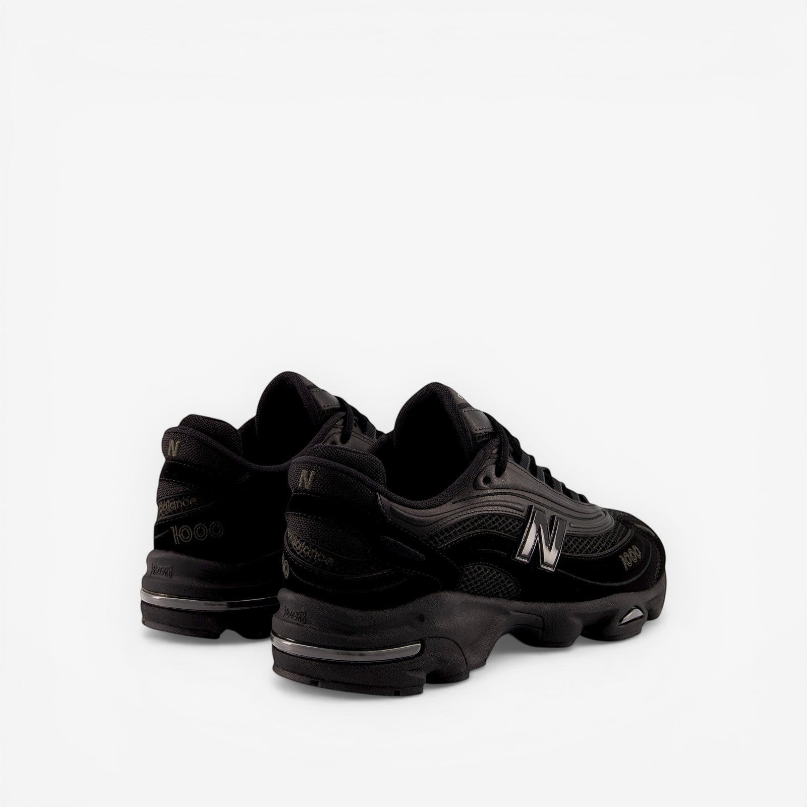 New Balance black sneakers, mesh and suede upper, bold N logo, premium footwear