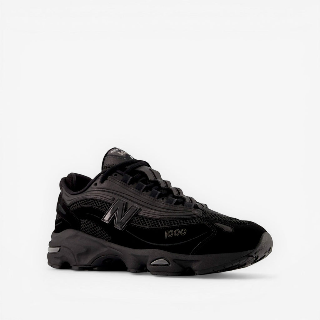 Black New Balance sneaker with mesh and suede details, side view, premium footwear