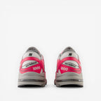 new balance 1000 sneakers in pink and gray, rear view, mesh and leather footwear