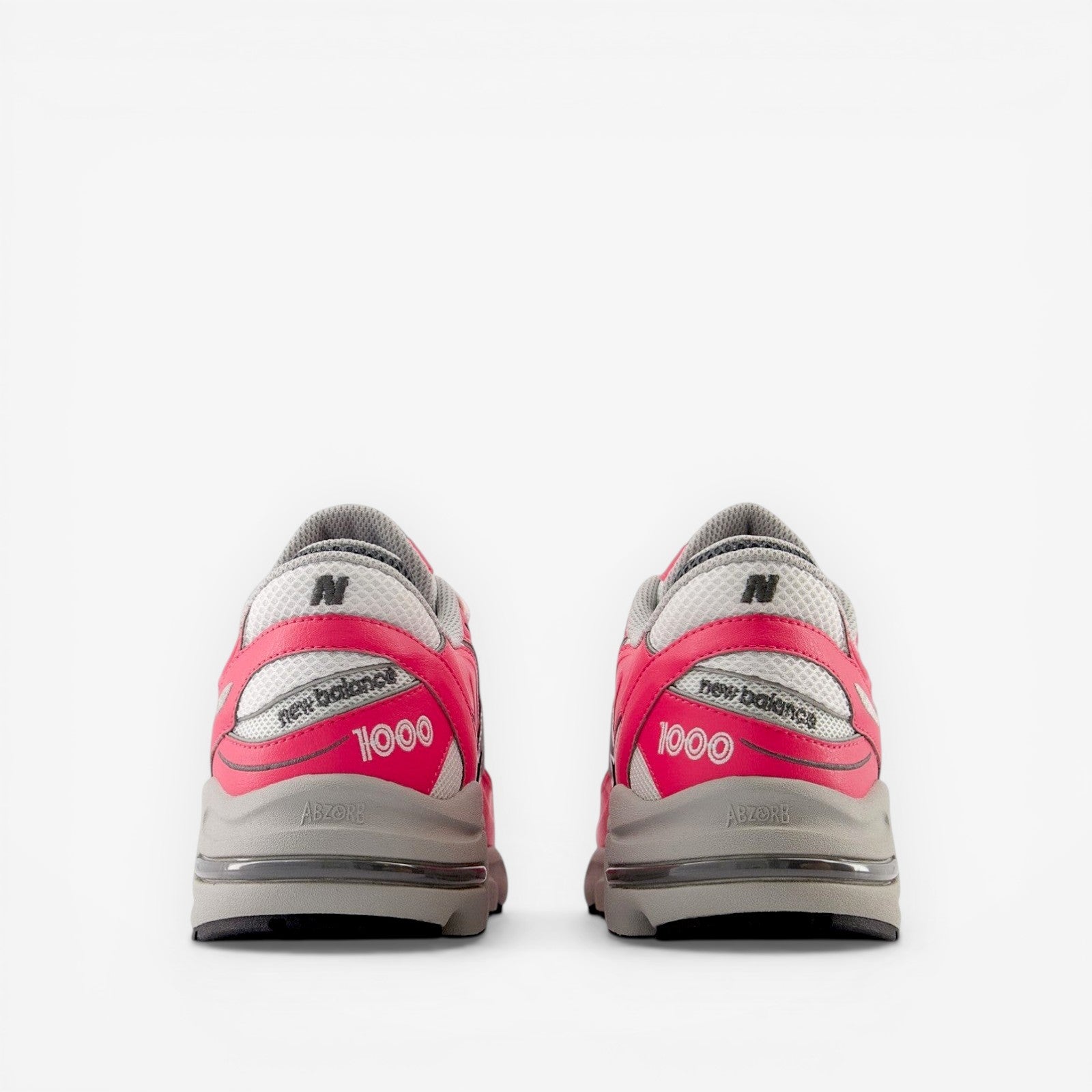 new balance 1000 sneakers in pink and gray, rear view, mesh and leather footwear