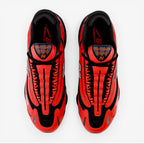 Top view of New Balance 1000 orange sneakers, black mesh upper, premium footwear.
