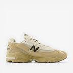 Beige New Balance sneaker with mesh and suede details, side profile, premium footwear