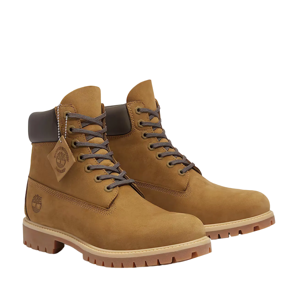 Pair of brown leather boots with a visible brand logo on a white background