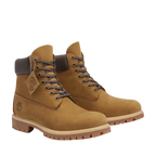Pair of brown leather boots with a visible brand logo on a white background