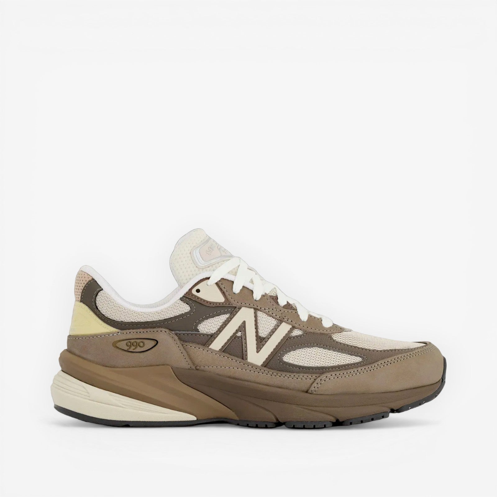 new balance sneaker in tan and cream tones, mesh and suede upper, side profile footwear