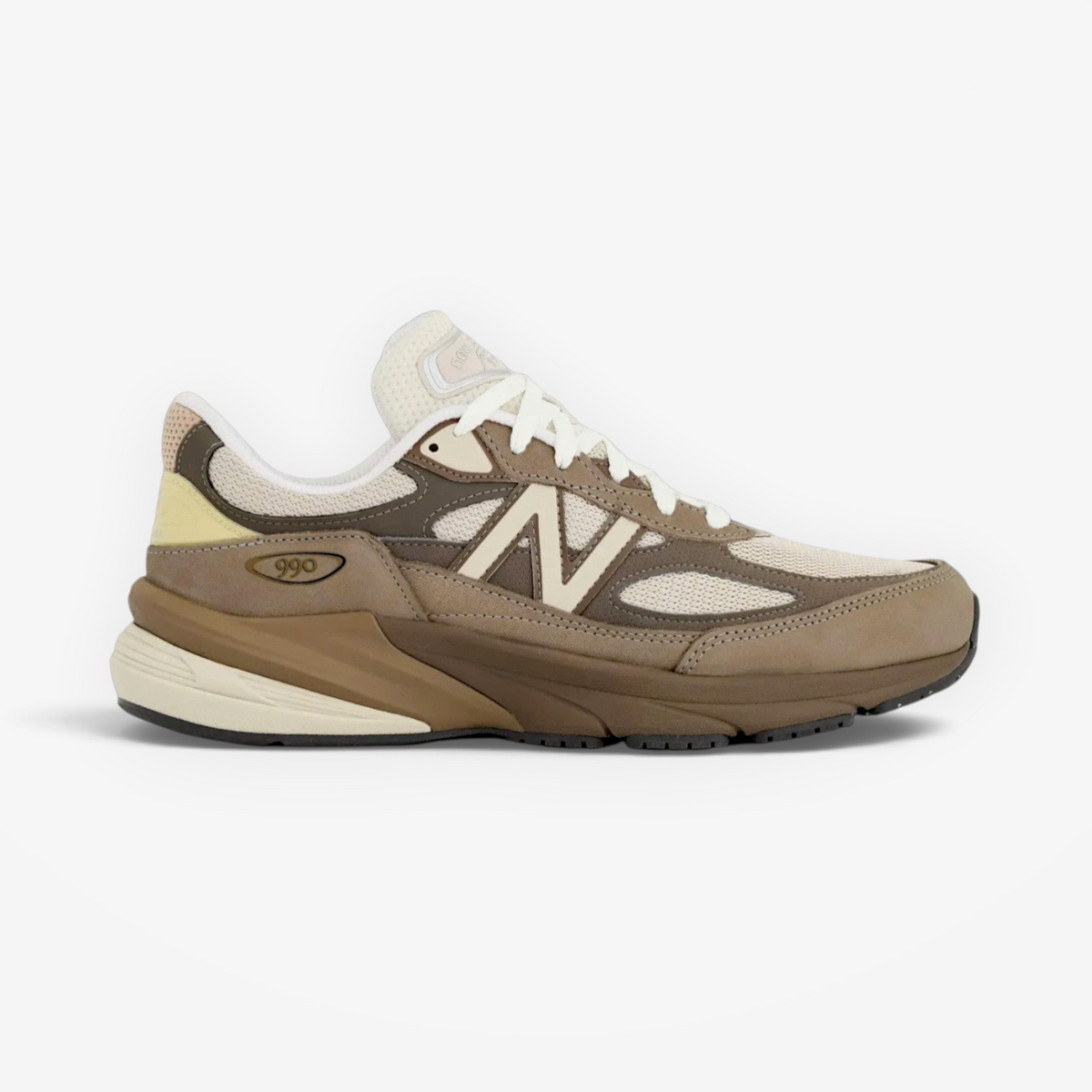 new balance sneaker in tan and cream tones, mesh and suede upper, side profile footwear