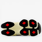 New Balance sneaker outsole with black, cream, and red accents, footwear detail
