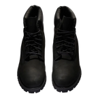 Pair of black leather boots on a white background