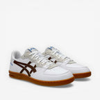 White sneakers with brown soles on a white background
