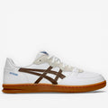 White sneaker with brown logo on a white background