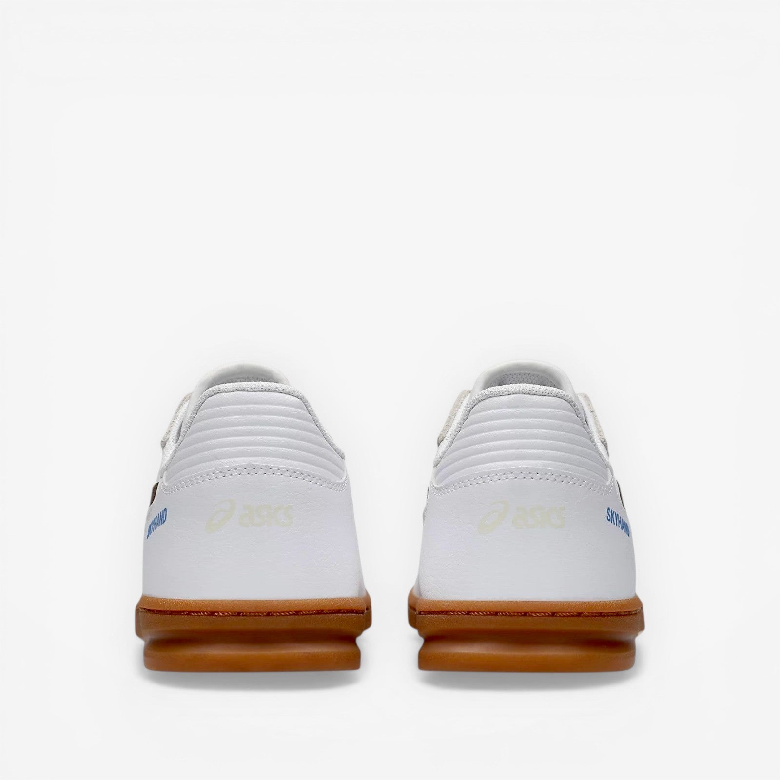 White sneakers with brown soles on a white background