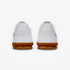White sneakers with brown soles on a white background