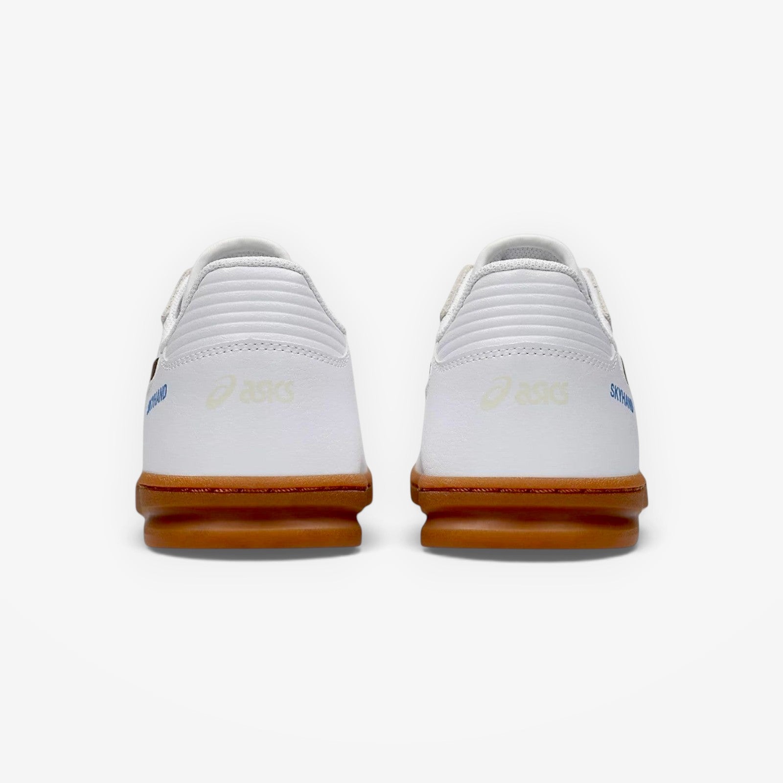 White sneakers with brown soles on a white background