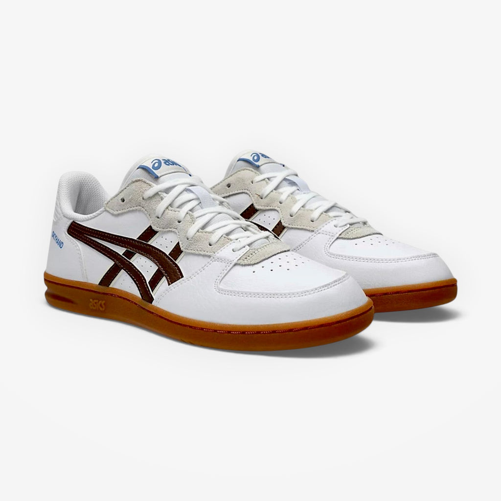 White sneakers with brown soles on a white background