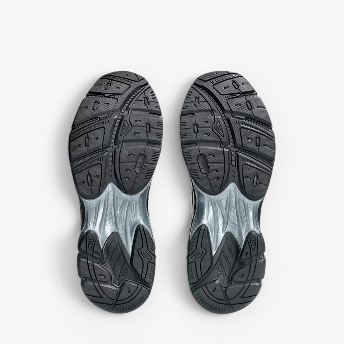 METRO ASICS GT-2160 sneaker outsoles showing black rubber tread pattern and sculpted midsole design
