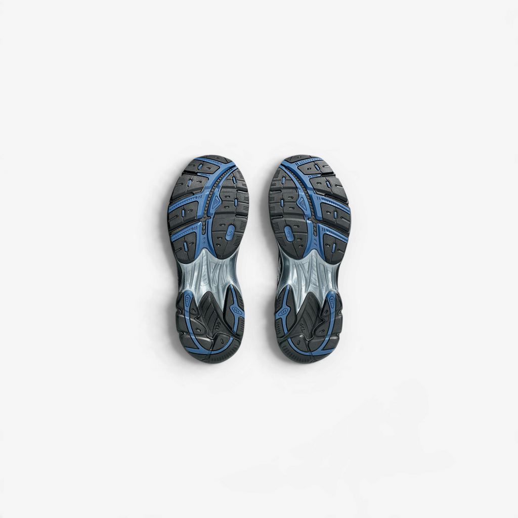 METRO ASICS GT-2160 sneakers in midnight and black showing the detailed blue and black rubber outsoles from below.