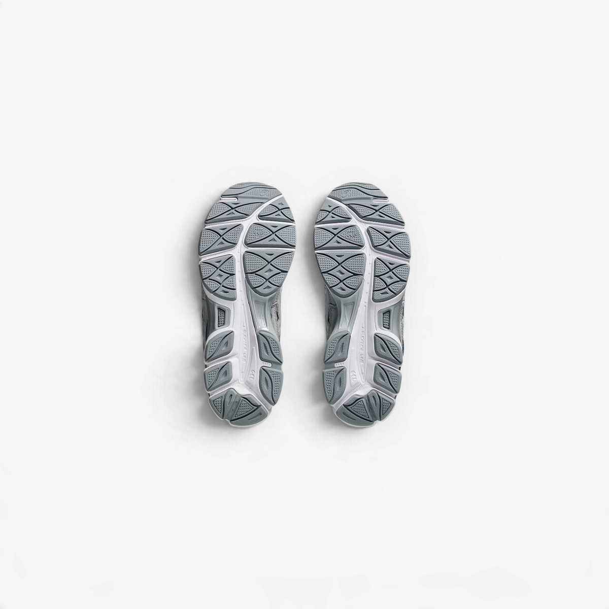 METRO ASICS GEL-NYC sneakers showing the grey rubber outsoles with textured grip patterns and GEL cushioning details.
