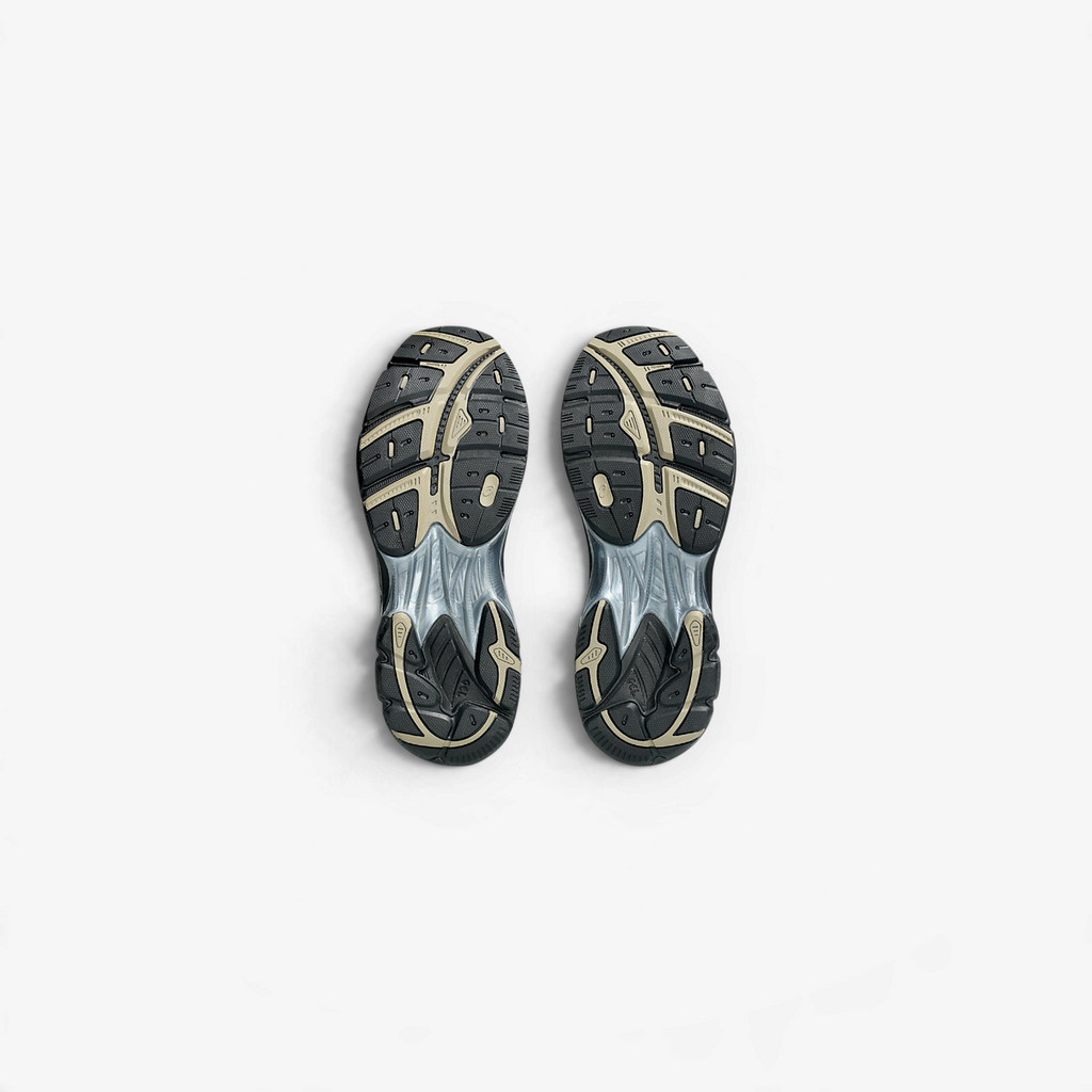 METRO ASICS GT-2160 sneakers in cocoa powder and black, showing the detailed tread pattern of the segmented outsoles.