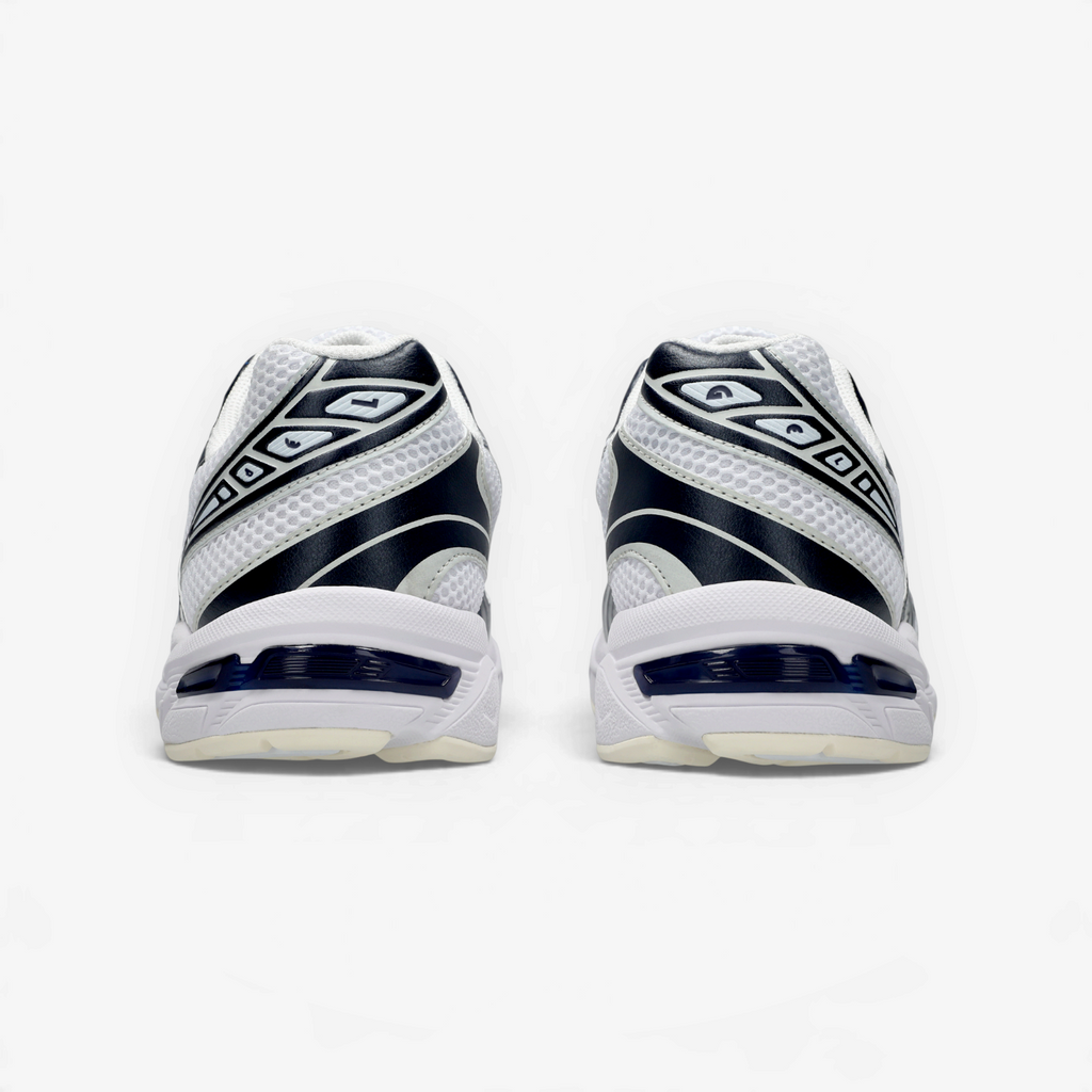METRO ASICS GEL-1130 retro running shoes in white and midnight blue, showing the heel cushioning and layered design.