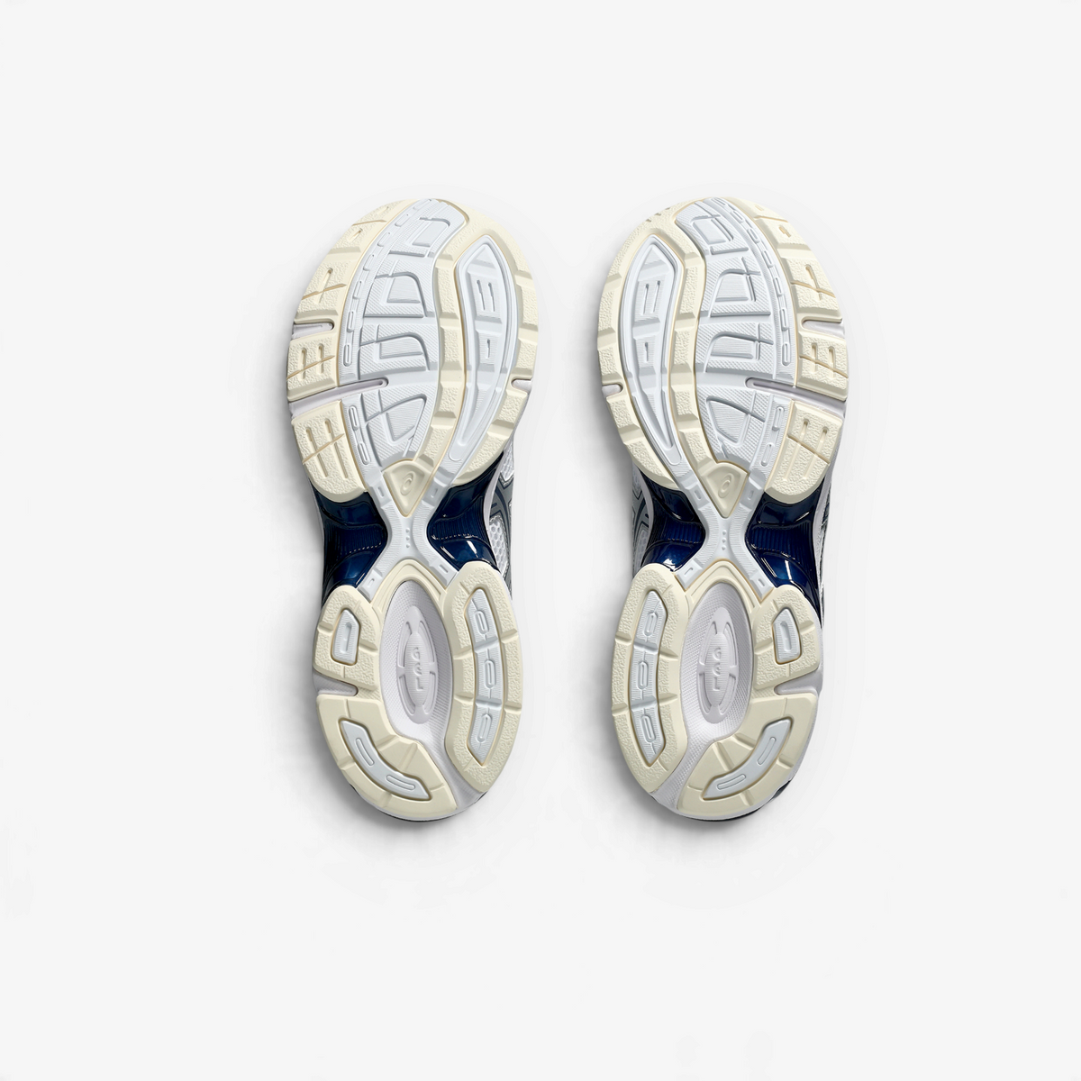 METRO ASICS GEL-1130 retro running shoes in white and midnight blue, showing the durable rubber outsoles.