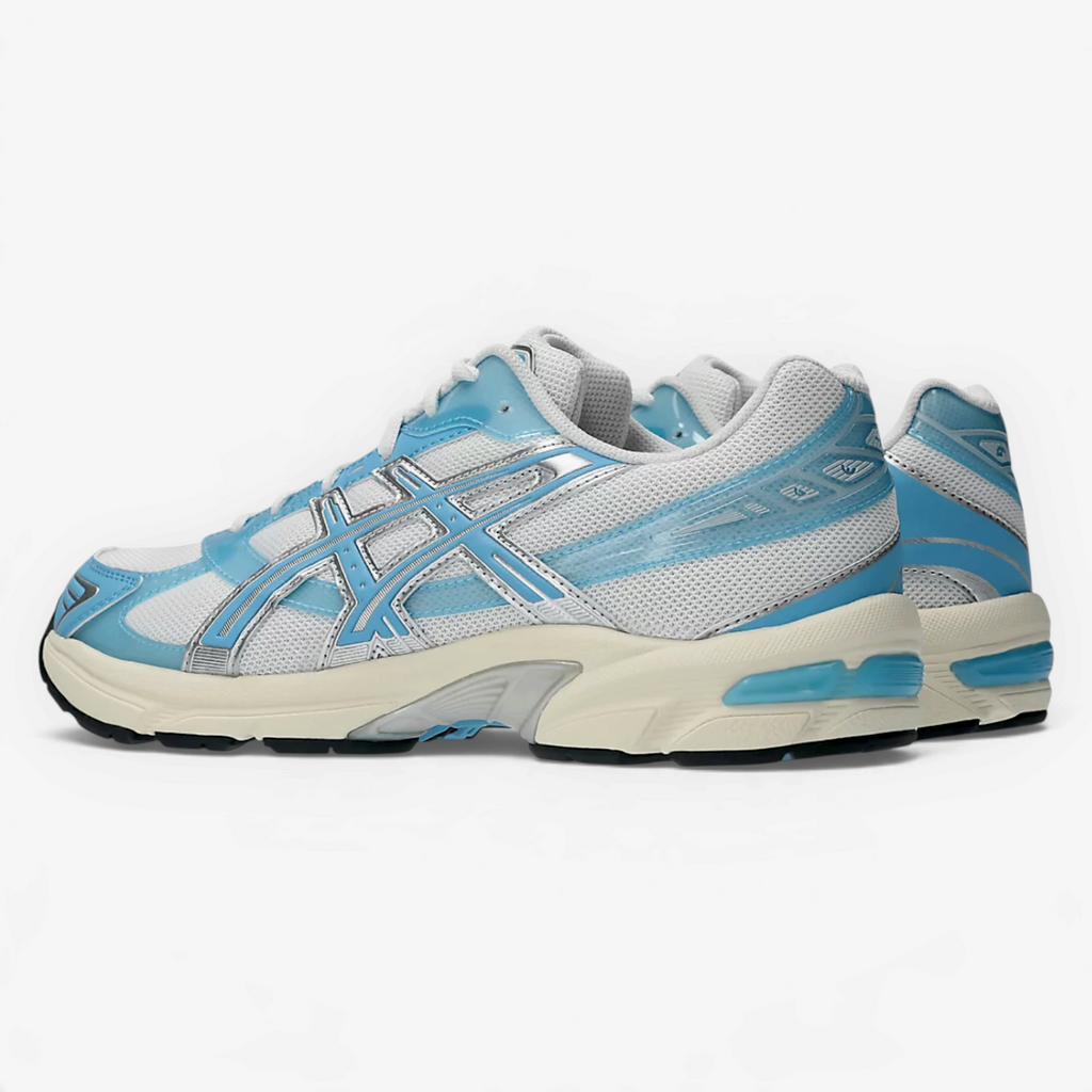 METRO ASICS GEL-1130 sneakers in white and storm cloud with layered mesh and glossy TPU details, side view.