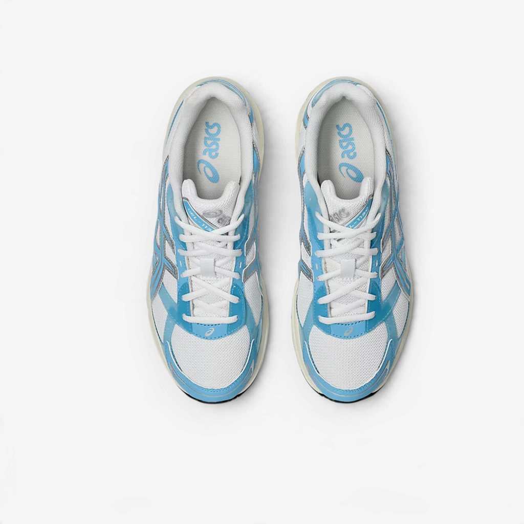 METRO ASICS GEL-1130 sneakers in white and storm cloud blue with technical mesh and glossy TPU details, top view.